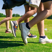 Three golfers walking, each wearing Midnight, Natural, and Black Monochrome Low socks